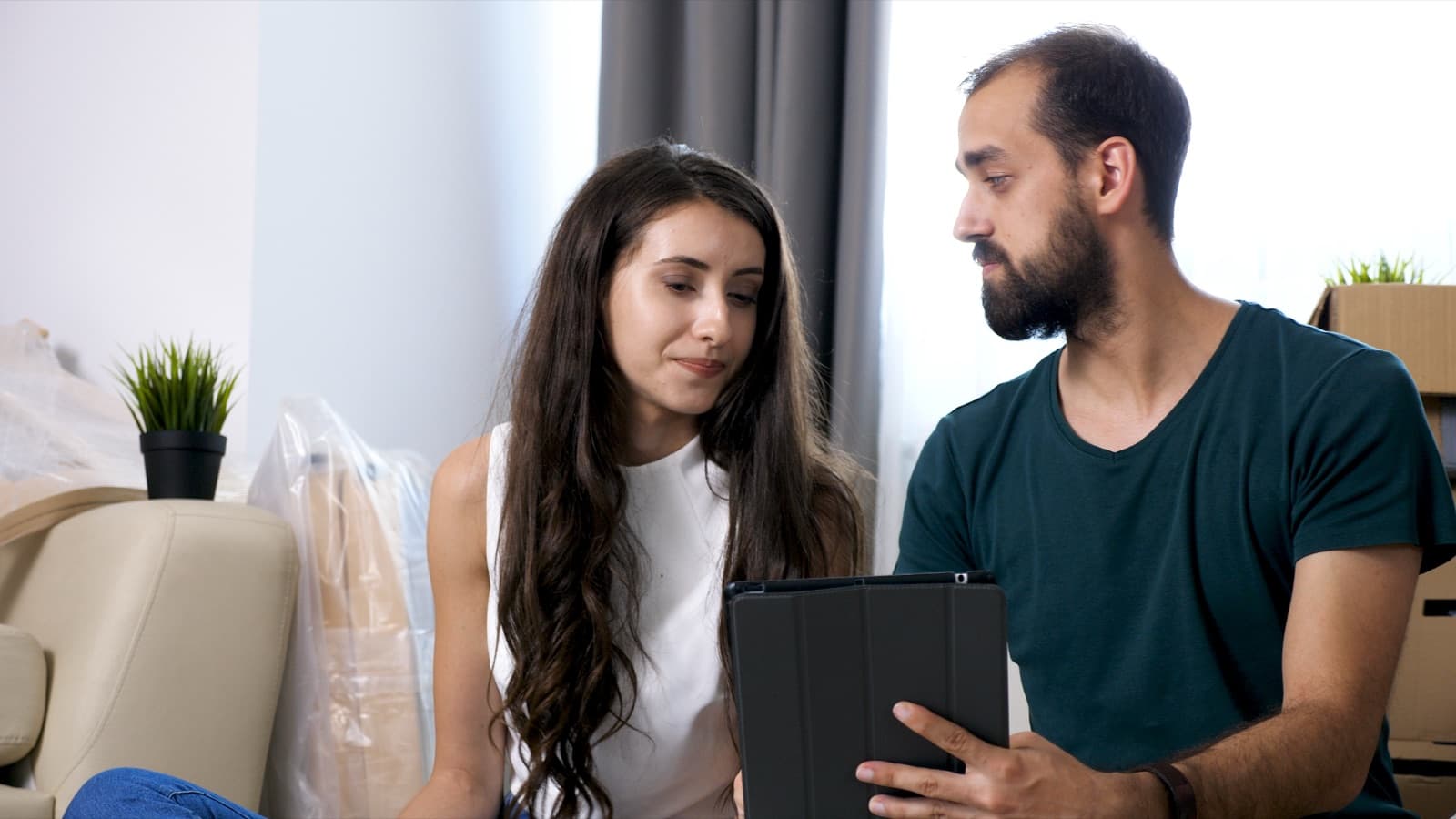 A couple weighing up a financial decision together at home