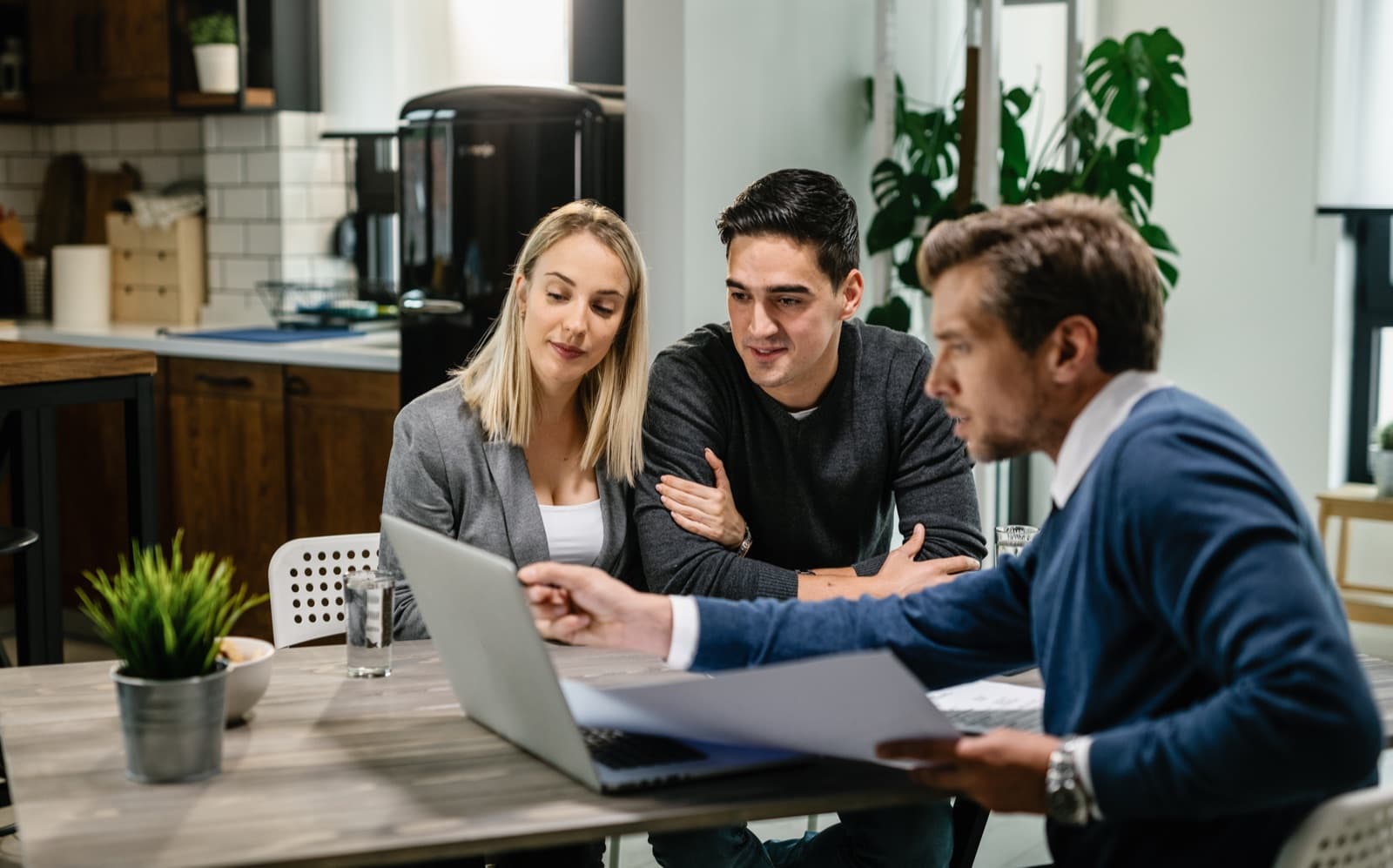 A couple reviewing their superannuation options with an adviser at home
