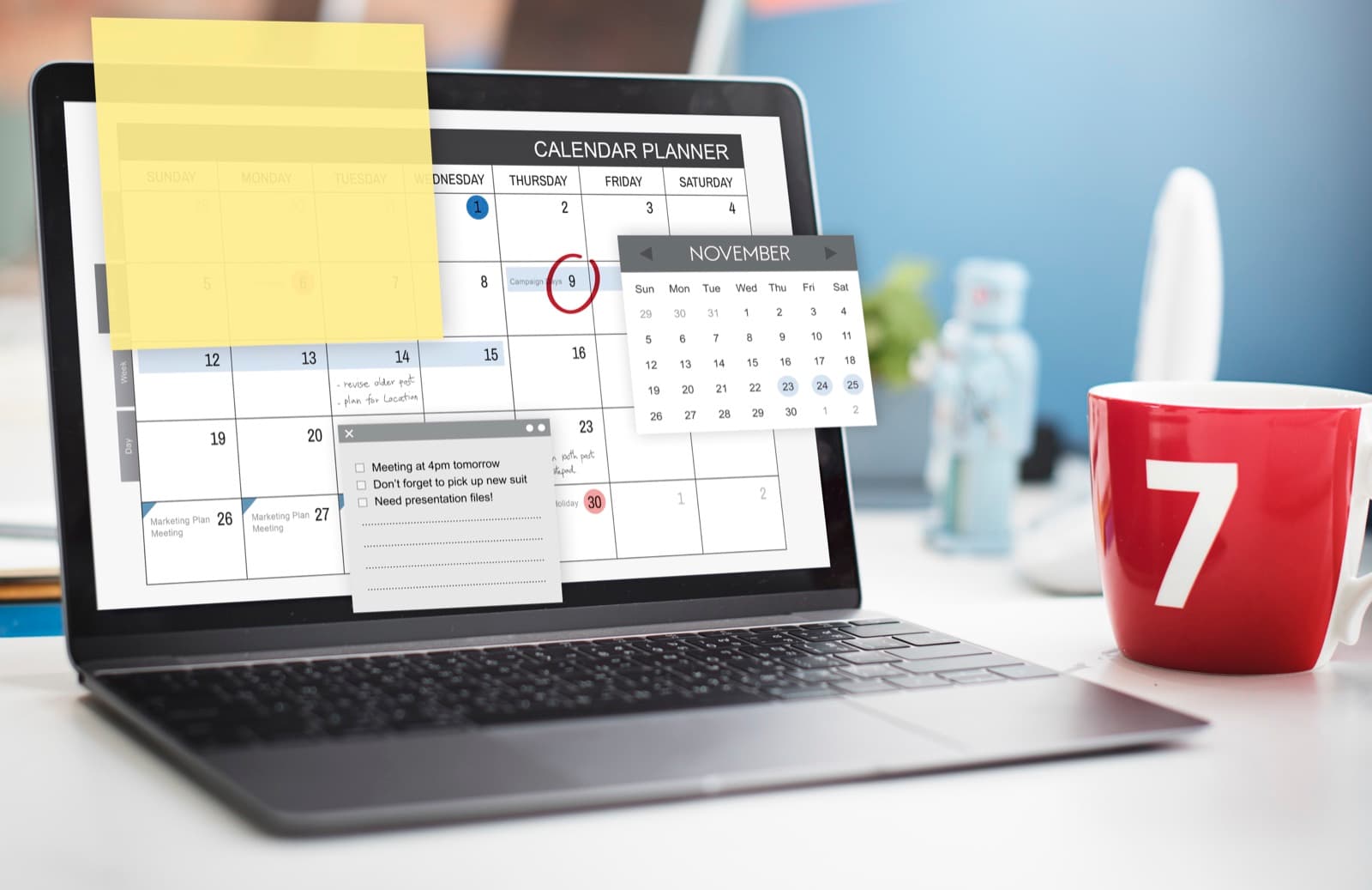 A calendar planner open on a laptop on a desk