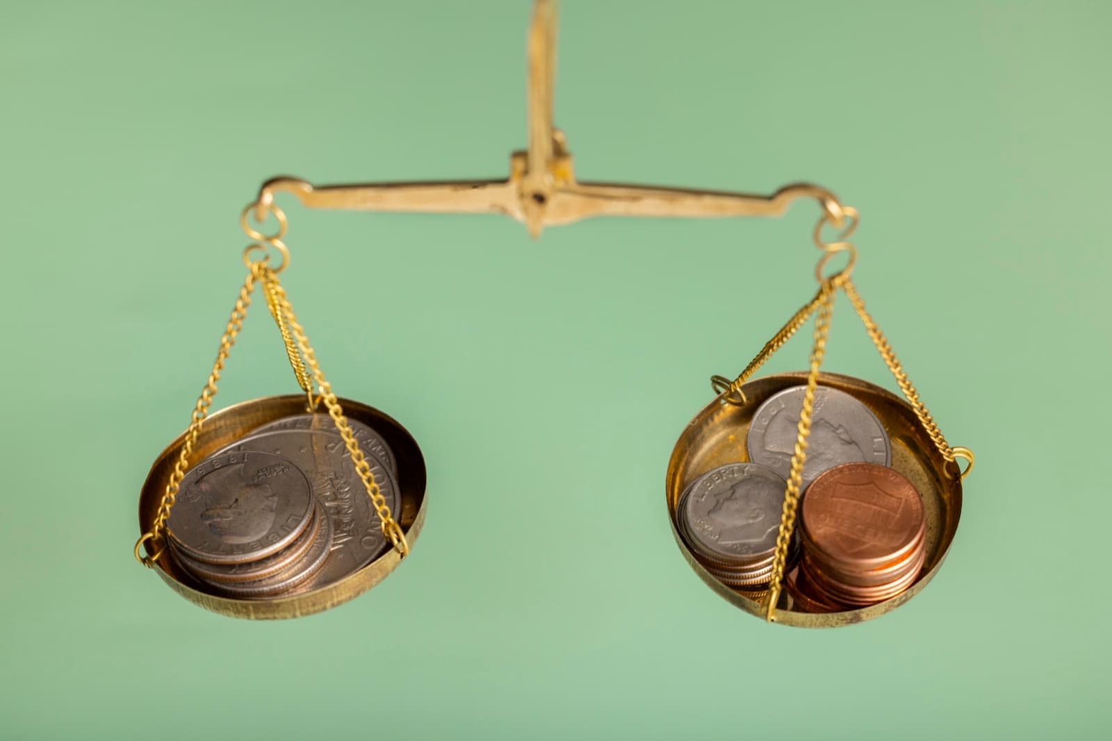 A balance scale holding coins on each side