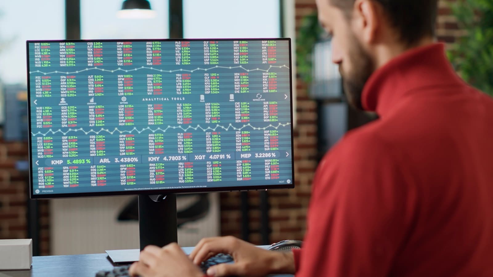 An investor reviewing stock market charts on a screen