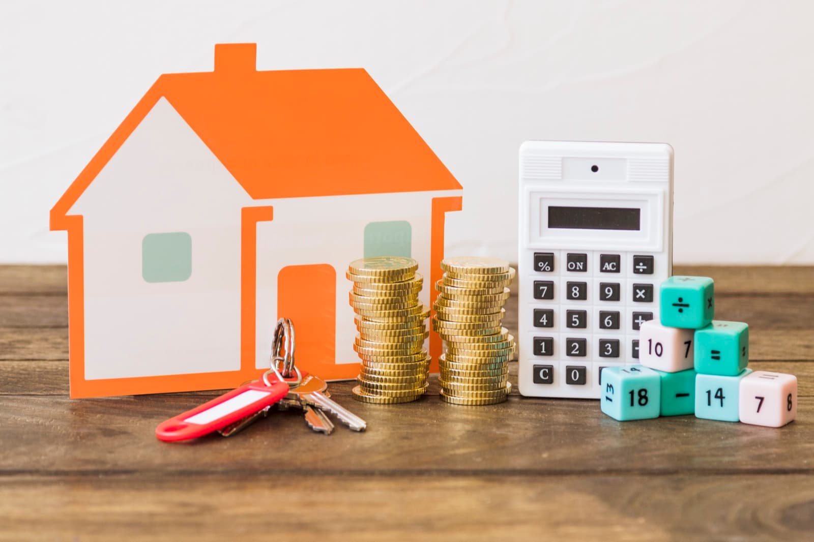 A model house with coins and a calculator