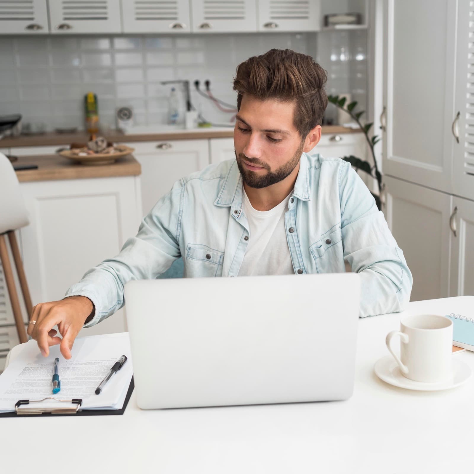 A person managing their super online at home on a laptop