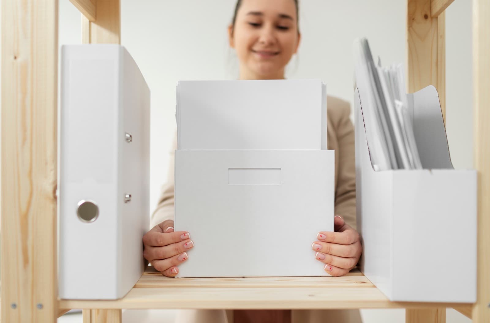 A person organising files into a storage box