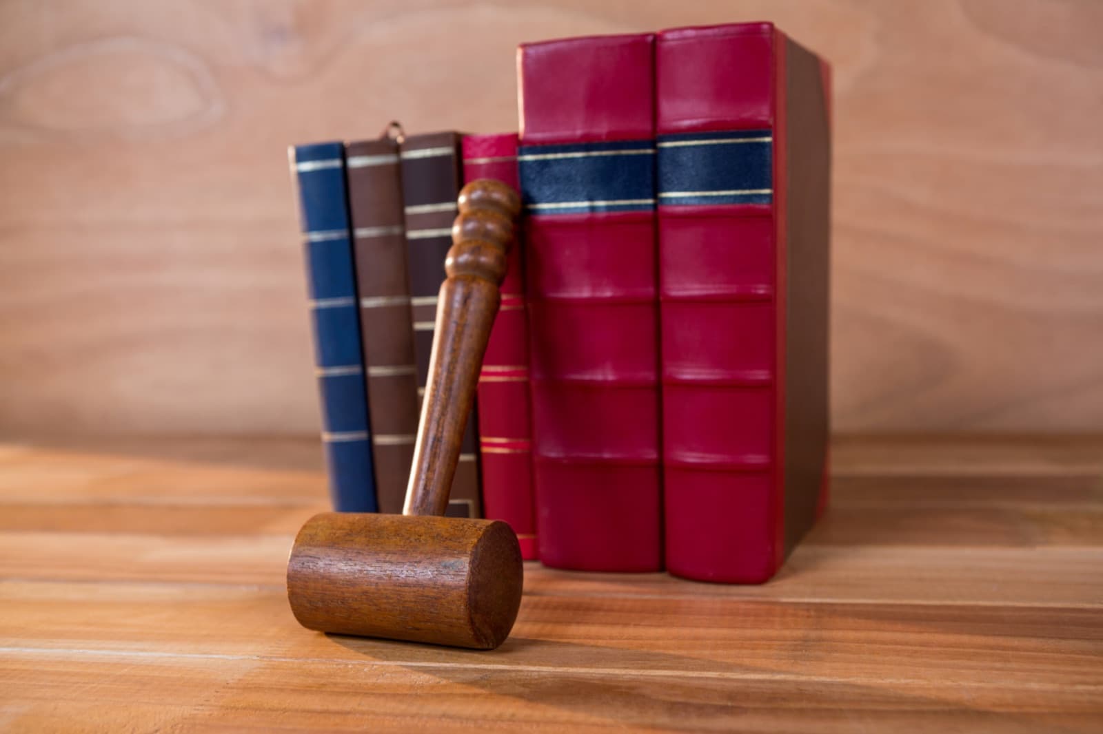Law books beside a wooden gavel