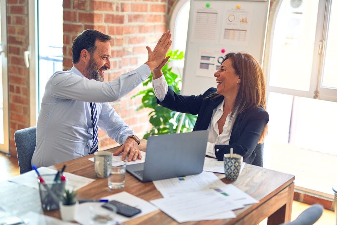 Business owner managing BAS due dates and compliance with financial documents, calendar, and laptop in a well-organized office.
