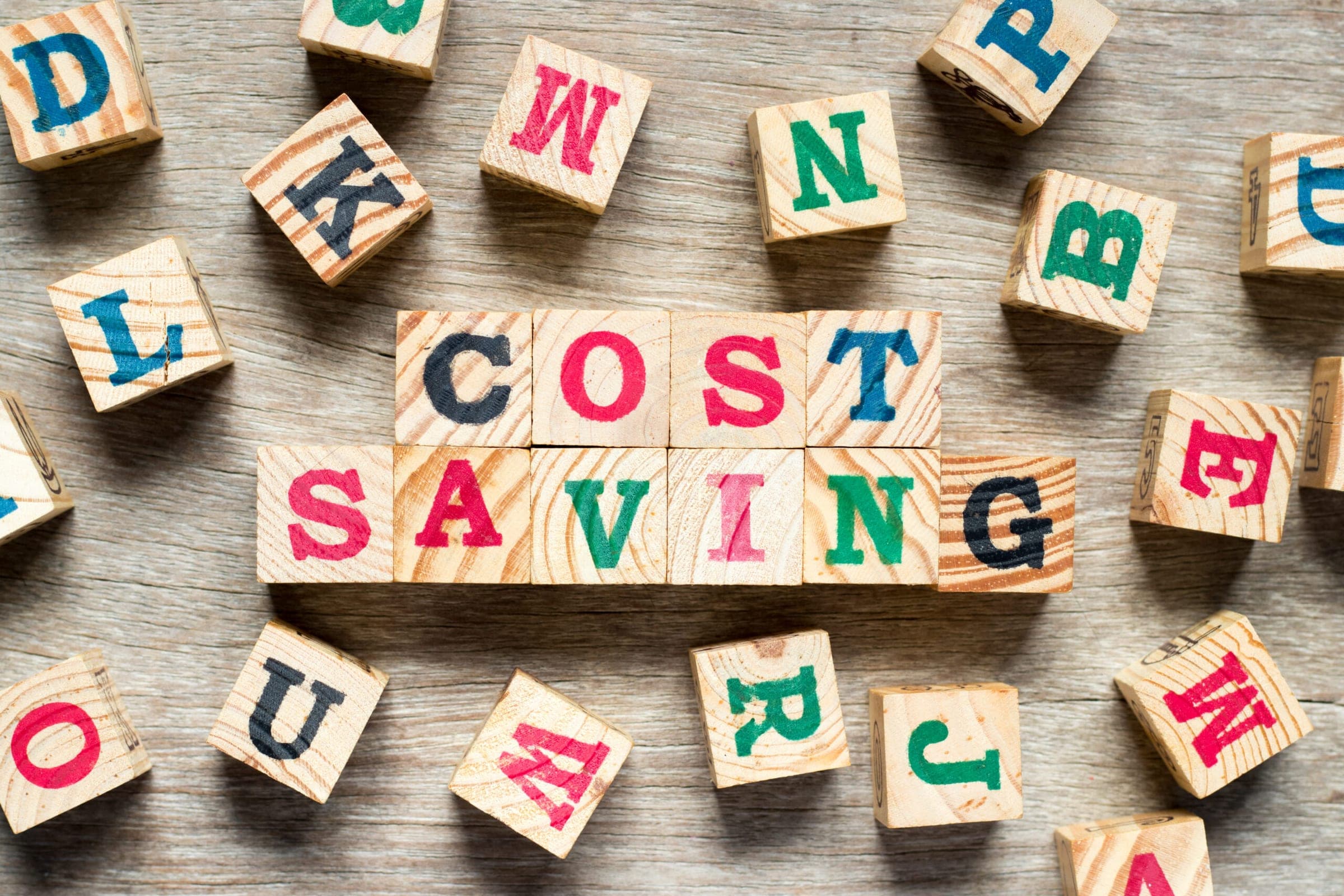 Colorful wooden blocks spelling 'Cost Saving' for debt recycling article.