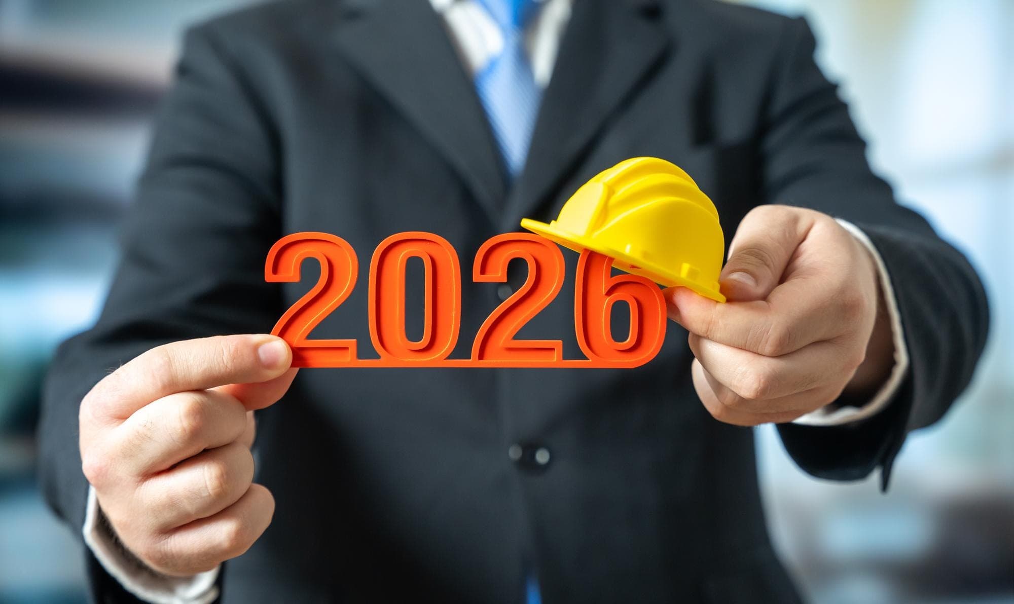 Businessman holding 2026 numbers with a hard hat, topic on ATO rules.