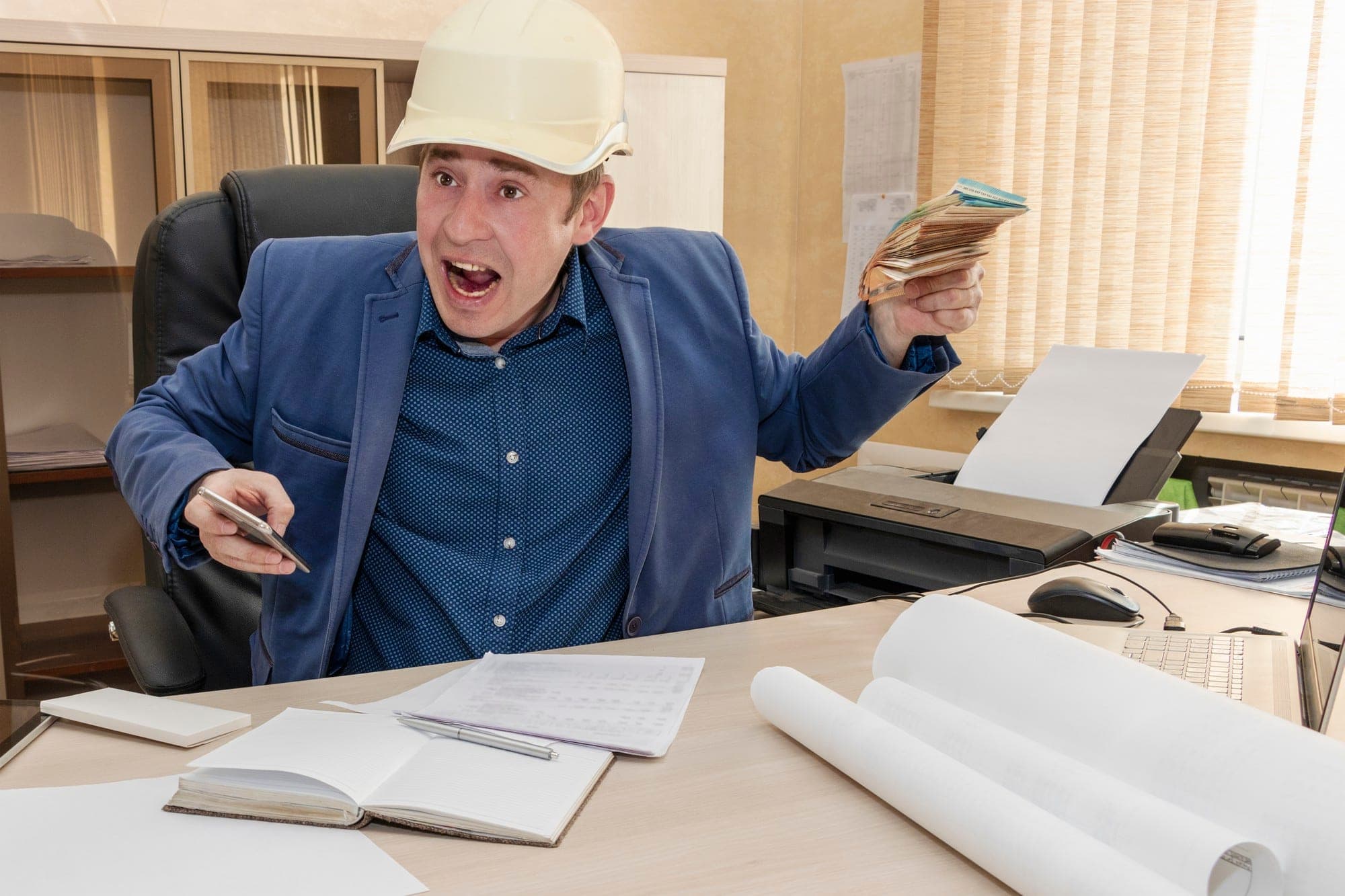 Frustrated contractor with helmet discussing Queensland payroll tax on subcontractors.
