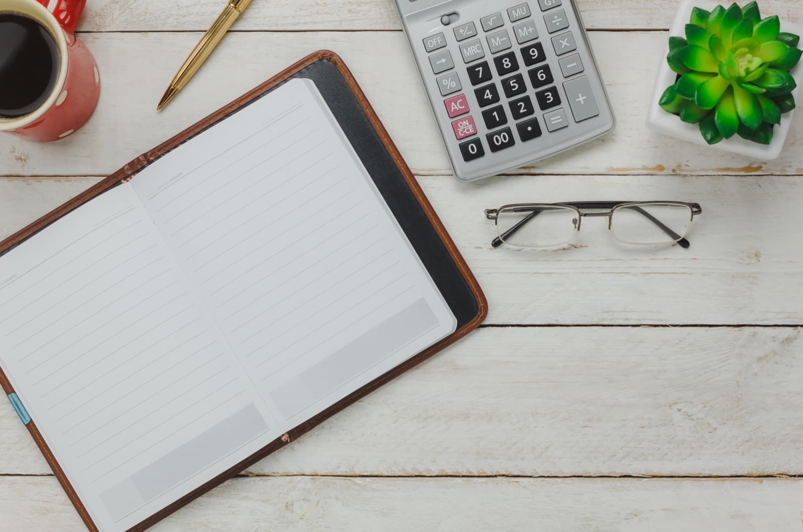 A calculator and paperwork on a desk