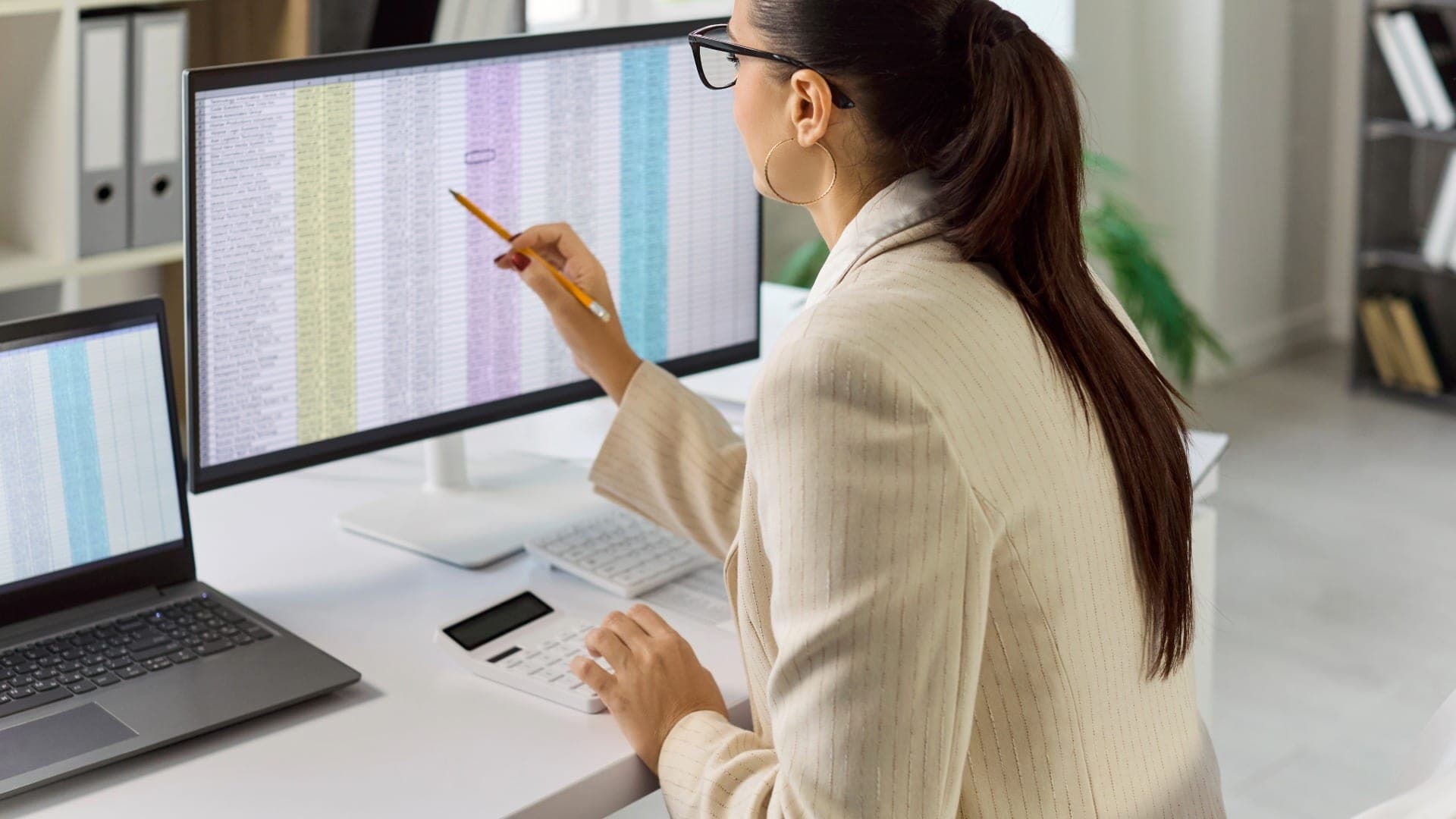Businesswoman analyzing data for Single Touch Payroll Phase 2 reporting.