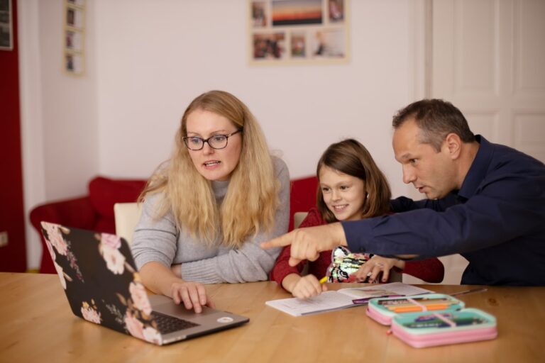 Australian parents in Brisbane checking investment bond growth projections on a laptop to plan school fees