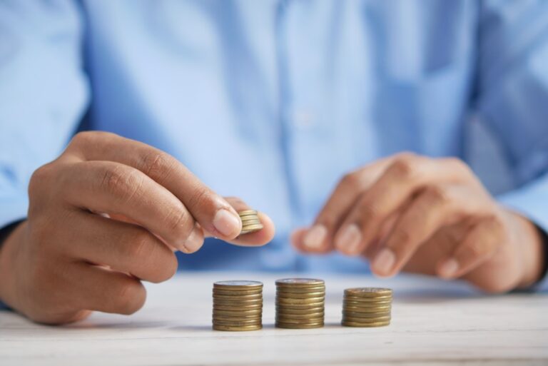 Parent drops a coin into a clear jar labelled “Education Fund”, symbolising an investment bond growing for a child’s future schooling costs