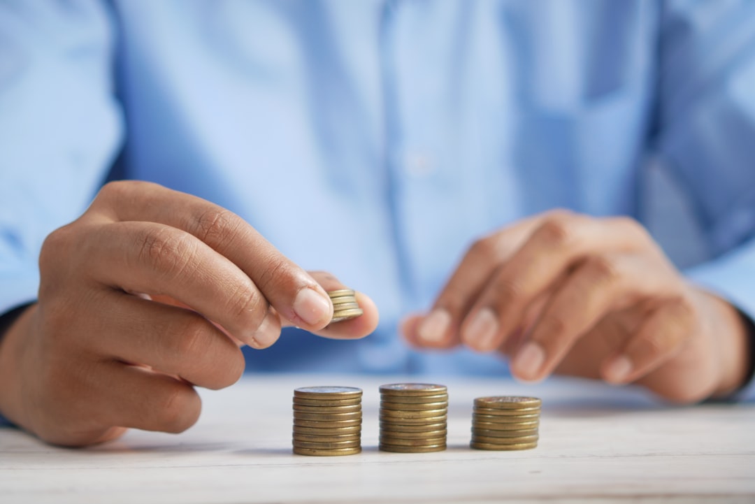 Parent drops a coin into a clear jar labelled “Education Fund”, symbolising an investment bond growing for a child’s future schooling costs