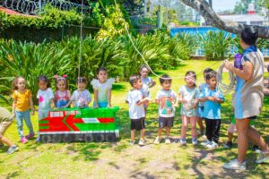 Primary-school children in Queensland playing chase on a sunny oval, symbolising the future education costs their parents plan to fund with an investment bond