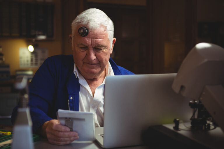 Elderly man at laptop managing finances, ATO wealth transfer focus